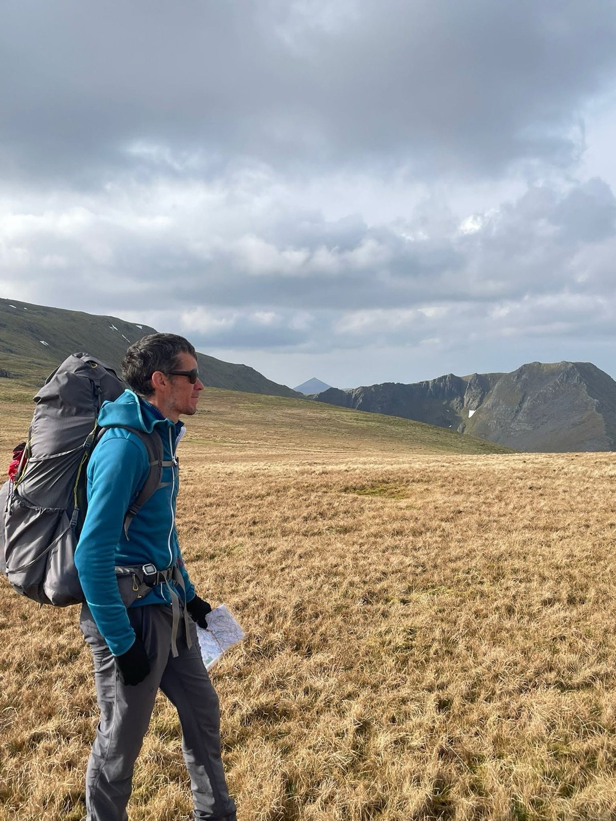 Map in hand below Helvellyn's edges, Lake District